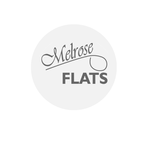 A white circle with the words "Melrose Flats" written in black.
